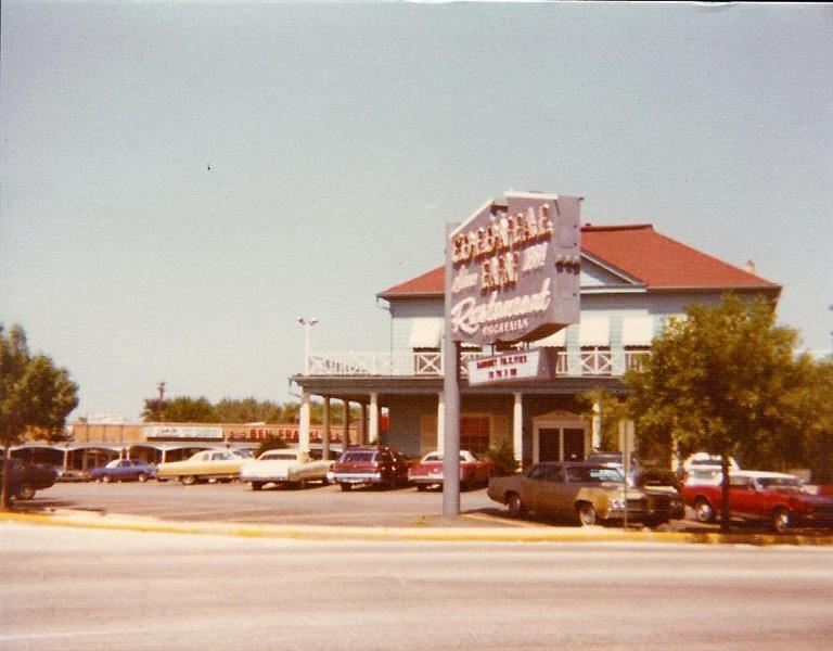 Old photo of a large building across the road.